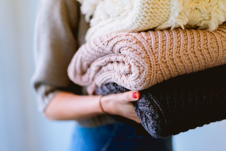 A women with freshly washed clothes in her hand.